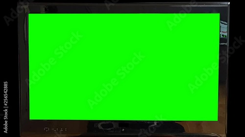Modern flat Tv Green Screen on black Background Zooming out Slowly. Replace green screen with your own text or footage.