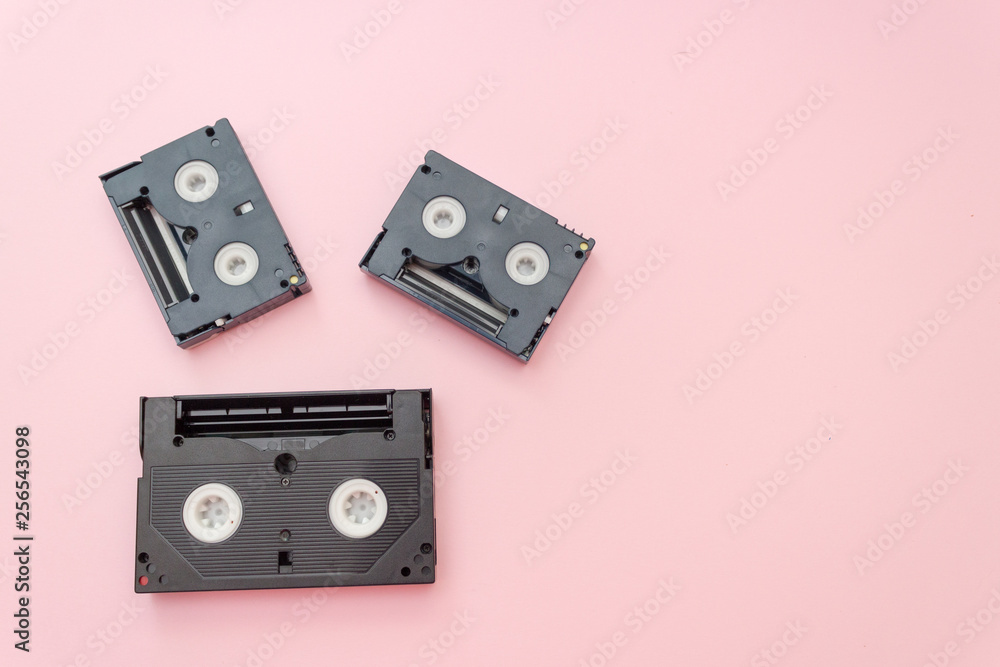 Fototapeta premium Old VHS videotapes, retro concept. Video cassette on a pink background