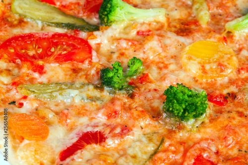 Delicious pizza with broccoli, tomatoes and vegetables, with cucumber and pepper