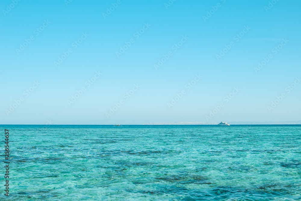 Wide shot of a beautiful clear turquoise sea ocean water surface with low ripples and subtle waves on seascape background, horizontal picture. Vacation travel background with copyspace for your text