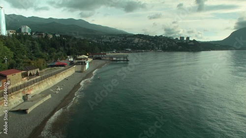Wallpaper Mural Aerial view: Sea, beach, sea, resort town of Feodosiya, Crimea. Shot. Beach from aerial view tourists relaxing and swim, city view Torontodigital.ca