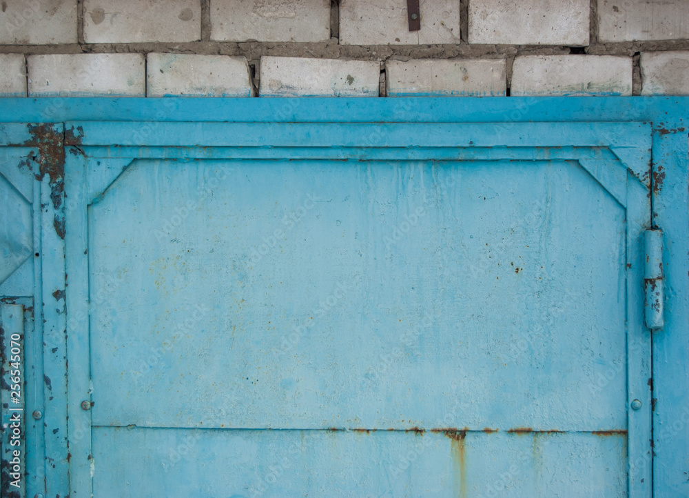 blue metal grunge closed door in brick wall blue metal grunge closed door in brick wall