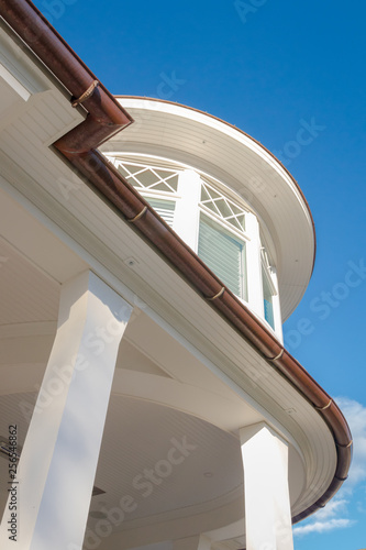 Home features including turret, columns, and copper rain gutter photo