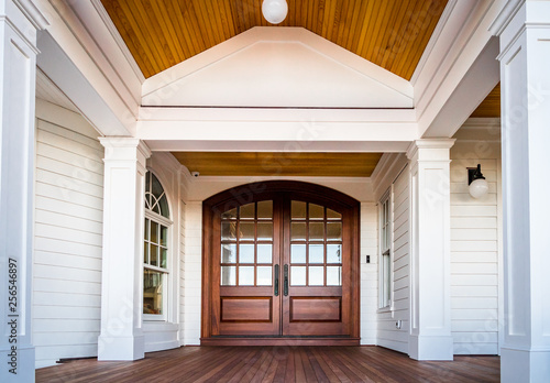 Front entry way of house featuring PVC trim, woodwork, columns, and deck