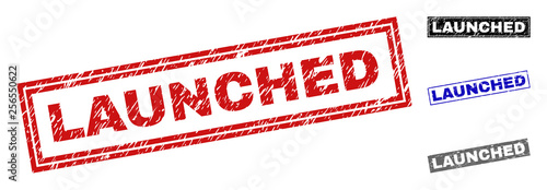 Grunge LAUNCHED rectangle stamp seals isolated on a white background. Rectangular seals with grunge texture in red, blue, black and grey colors.