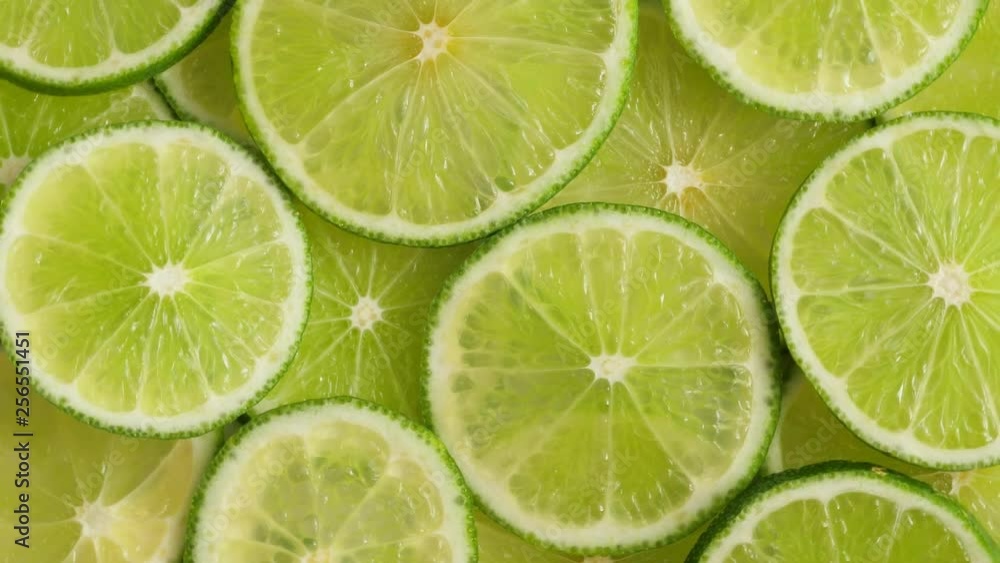 Lime slices closeup, macro background, fruits top view. Rotate Lime slices closeup, macro background, fruits top view. Rotate