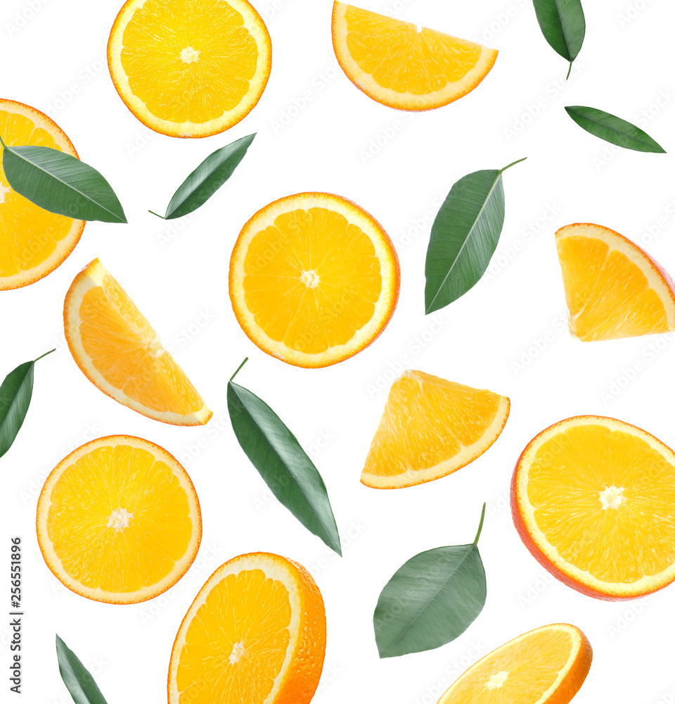 Naklejka Flying juicy orange slices and citrus leaves on white background