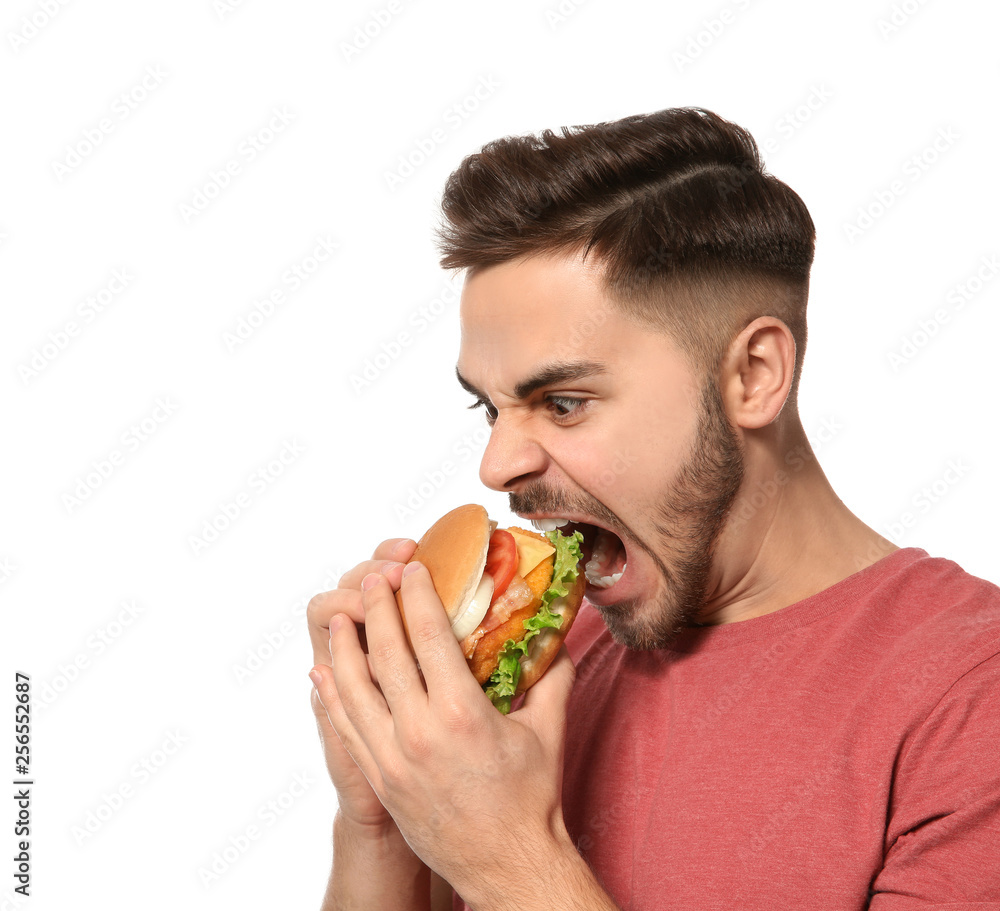 Handsome man eating tasty burger isolated on white Handsome man eating tasty burger isolated on white