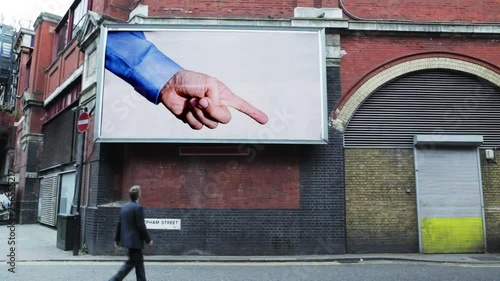 Billboard pointing at a pedestrian