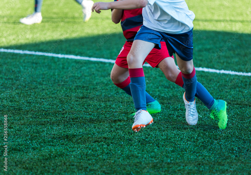 Football training soccer for kids. Boy runs kicks dribbles soccer balls. Young footballers dribble and kick football ball in game. Training, active lifestyle, sport, children activity concept Football training soccer for kids. Boy runs kicks dribbles soccer balls. Young footballers dribble and kick football ball in game. Training, active lifestyle, sport, children activity concept