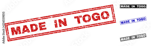 Grunge MADE IN TOGO rectangle stamp seals isolated on a white background. Rectangular seals with distress texture in red, blue, black and grey colors.