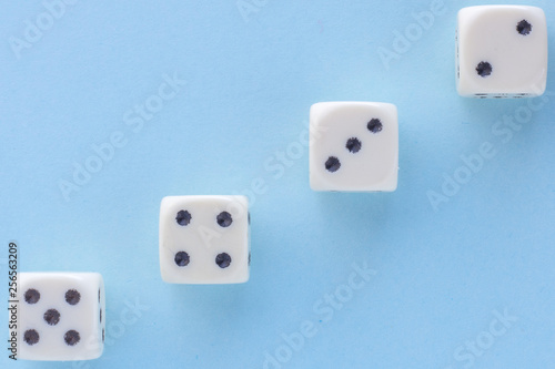 White gaming dices on light blue background. victory chance and lucky. Flat lay style  place for text. Top view and Close-up cube. Concept business  gamble and game. Spectacular background pastel.