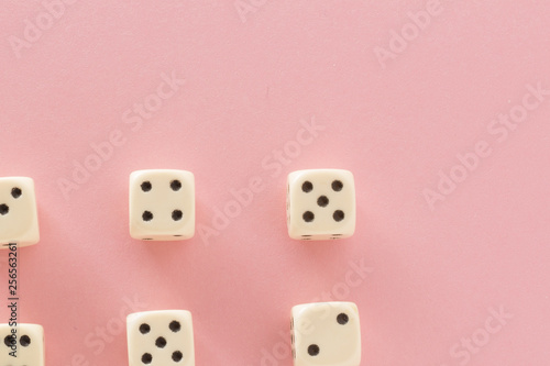 White gaming dices on pink background. victory chance and lucky. Flat lay style  place for text. Top view and Close-up cube. Concept business  gamble and game. Spectacular background pastel.