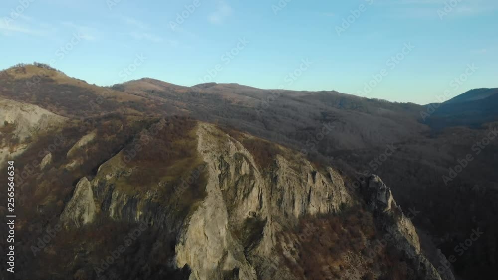 Aerial shot of mountain hill with forest and cliffs Aerial shot of mountain hill with forest and cliffs