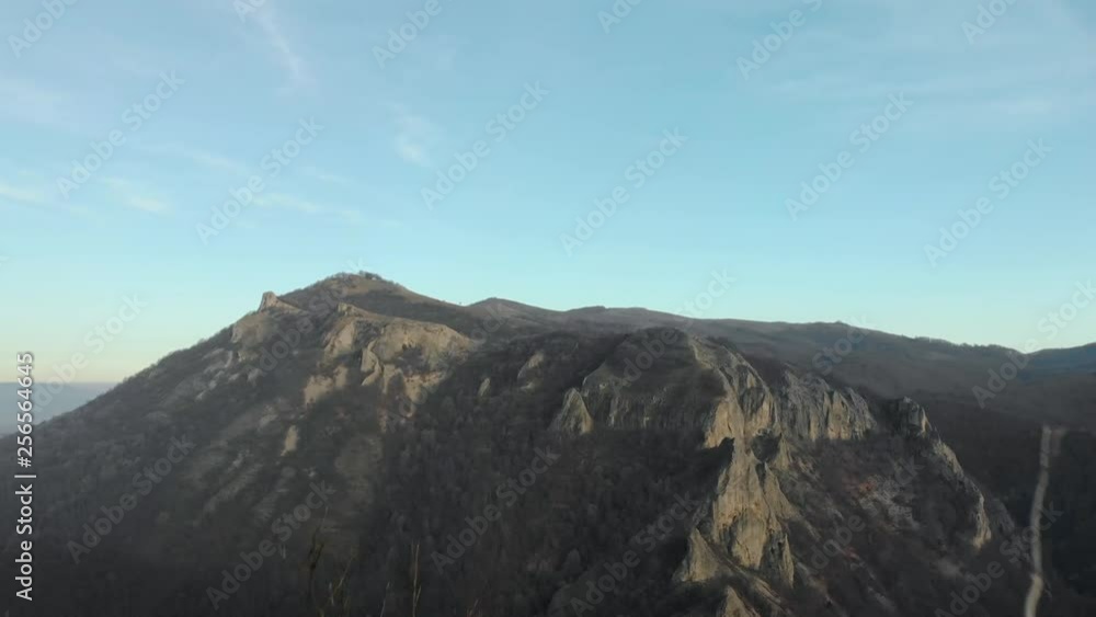 Aerial shot of mountain hill with forest and cliffs Aerial shot of mountain hill with forest and cliffs