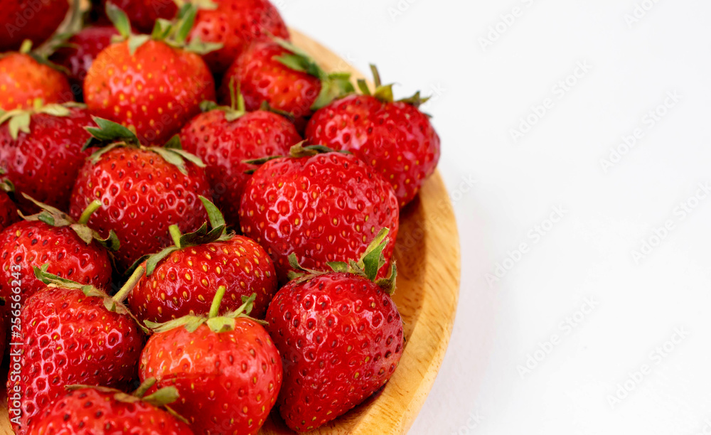 Strawberrys many with both ripe fruit and not fruit ripe in wooden tray Strawberrys and wooden tray all laid are on a white background. Strawberrys many with both ripe fruit and not fruit ripe in wooden tray Strawberrys and wooden tray all laid are on a white background.