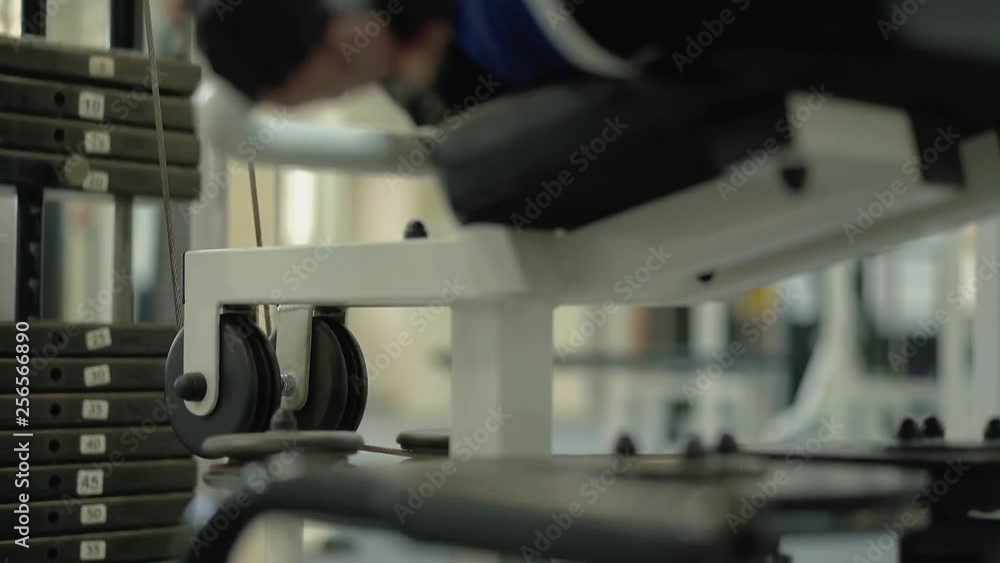 Man performs an exercise to strengthen the muscles of the legs. Classes are held in the sports hall for people with disabilities. Close up. Man performs an exercise to strengthen the muscles of the legs. Classes are held in the sports hall for people with disabilities. Close up.