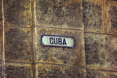 Photography Street sign in Havana with the name Cuba over a  wall