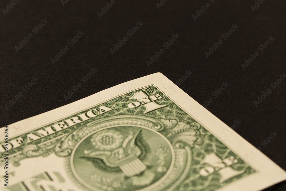 1 dollar bill on a dark background . Close up. The concept of saving money. 1 dollar bill on a dark background . Close up. The concept of saving money.