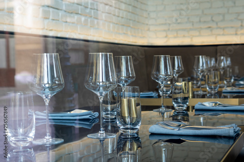 Festive table setting. Empty glasses, cutlery © Yakiv