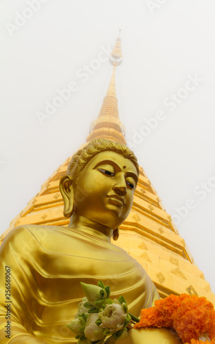 Buddha statue  Wat Phra That Doi Suthep in fog at Chiang mai province  Thailand.