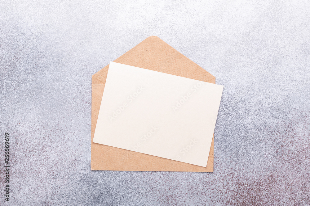 Fototapeta premium Blank paper with envelope on grey background