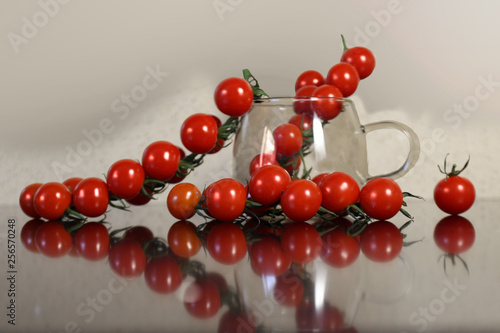 A branch of ripe tomatoes lying on the table