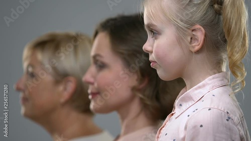 Side portrait of three female generations, birthrate and population ageing