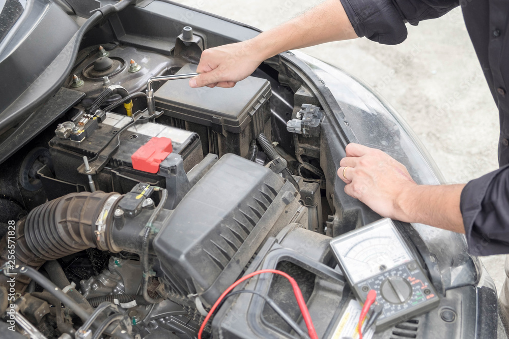 Maintenance car repair automotive concept, Man checking car mechanic working under car hood in garage Maintenance car repair automotive concept, Man checking car mechanic working under car hood in garage