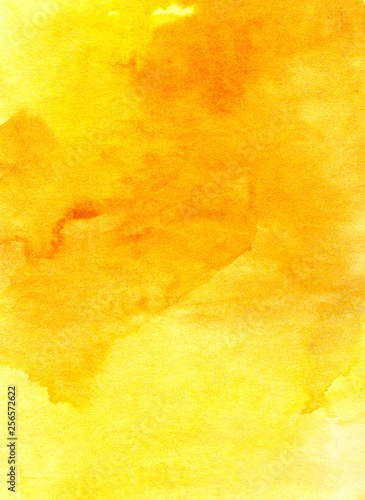 Abstract background. The texture of the paper, tinted with light and deep stains of yellow watercolor.