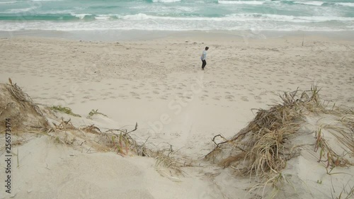 Adult male sandboarding at beach photo