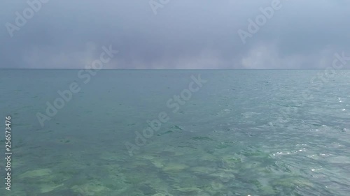 View over the clear water of lake Ontraio from Toronto Islands. Storm clouds in the distance photo