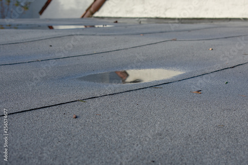 Fotografi Ponding rainwater on flat roof after rain,  roof drainage and leak problem