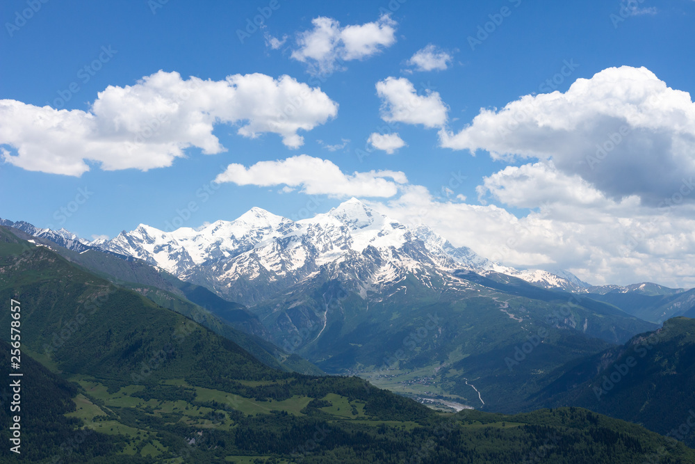 Caucasus mountains landscape in Georgia, Svaneti. Snowy mountain summit on clear summer day