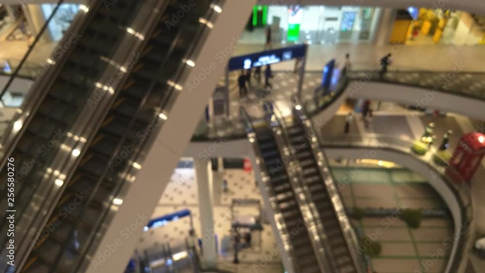 blur People on moving Escalators In big modern shopping mall. Consumption concept. blur People on moving Escalators In big modern shopping mall. Consumption concept.