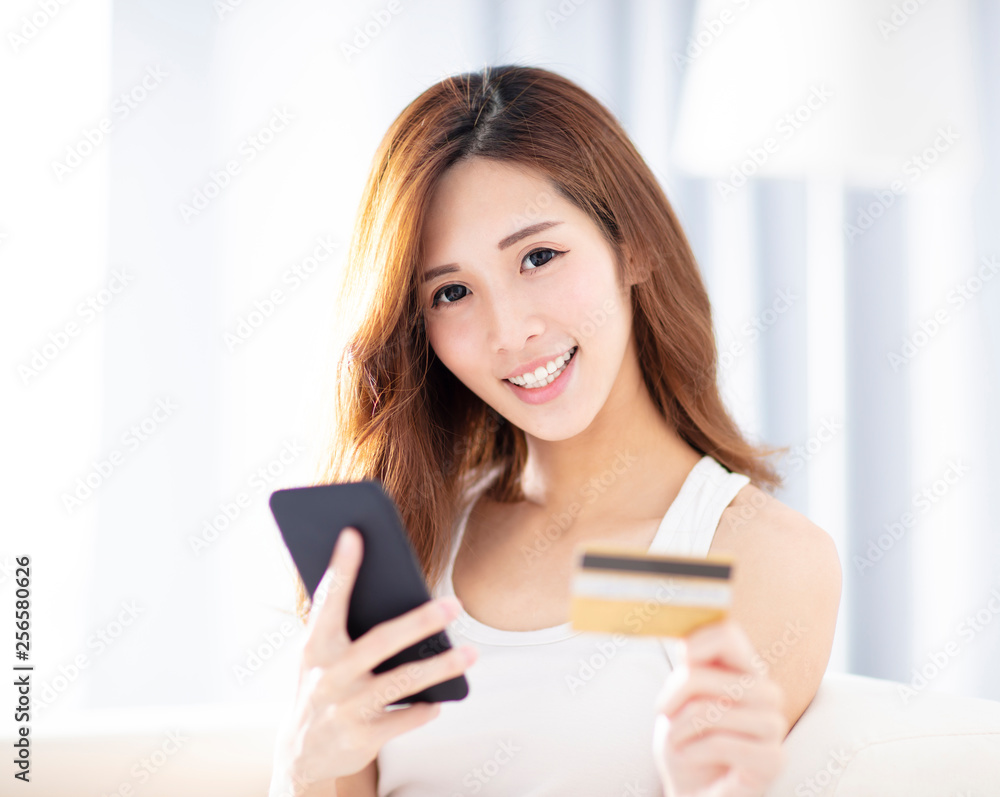 woman buying online with credit card and smart phone woman buying online with credit card and smart phone