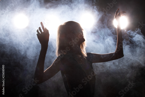 Fashion Young thin Asian Woman Tan skin eyes beautiful make up fashion dress accessories posing attractive glam look. Studio Lighting Dark Background smoke fog back rim light low exposure © Jade