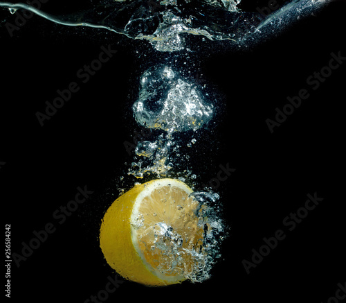 lemon in water on a black background