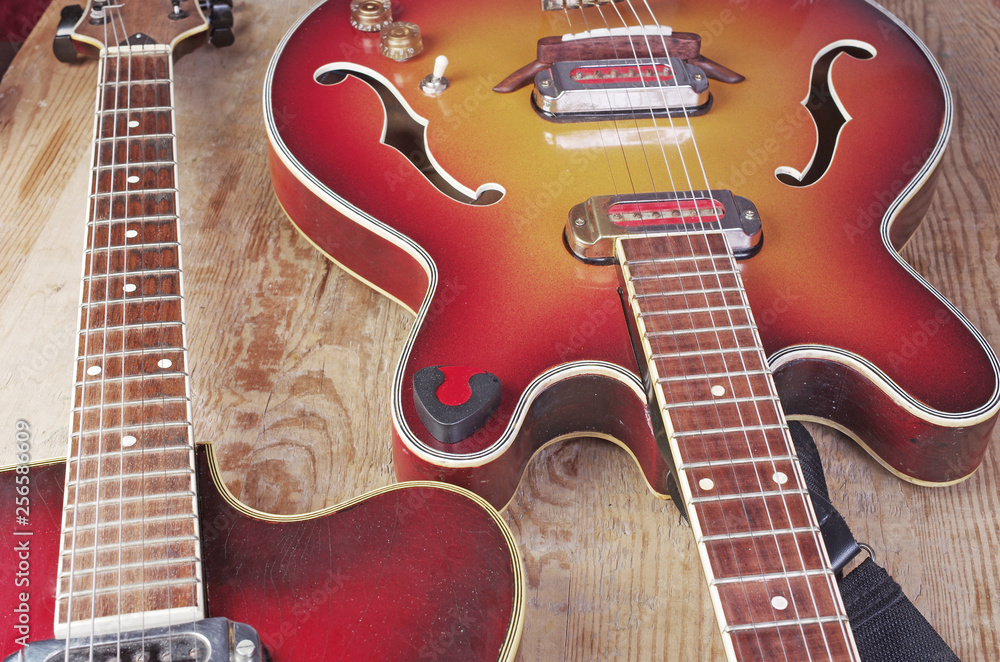 Two electric guitars on a wooden background. Two electric guitars on a wooden background.