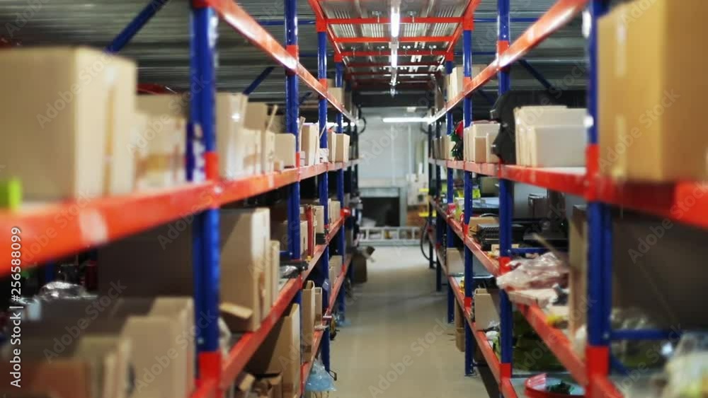 View inside the storehouse with tools and boxes on the colorful shelves. Lights turning off. Close-up. View inside the storehouse with tools and boxes on the colorful shelves. Lights turning off. Close-up.