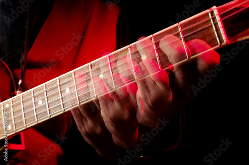 The dynamics of playing the guitar. Guitarist fingers spread all over the fretboard. Repeated exposure.