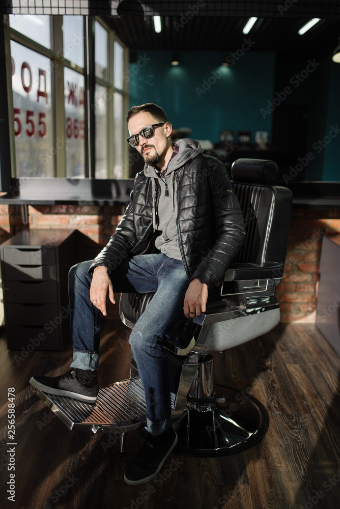 A man posing in a black winter jacket and jeans. Advertise menswear A man posing in a black winter jacket and jeans. Advertise menswear