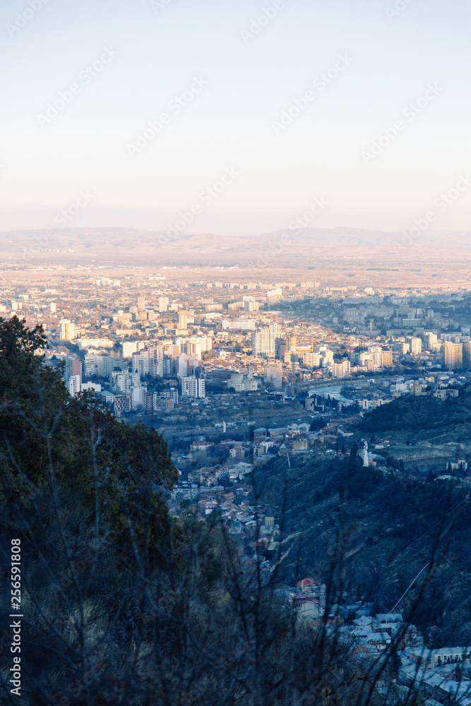 Obraz premium Sunset and evening city Tbilisi, Georgia. Panoramic views and lights of historic neighborhoods.