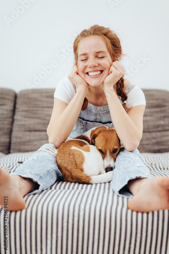 Cute young woman with her small dog