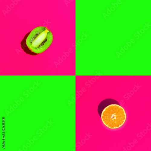 Ripe juicy halved orange kiwi on duotone bright neon fuchsia pink green background with blank squares for text. Healthy lifestyle vegan vitamins summer superfoods concept. Creative food art poster