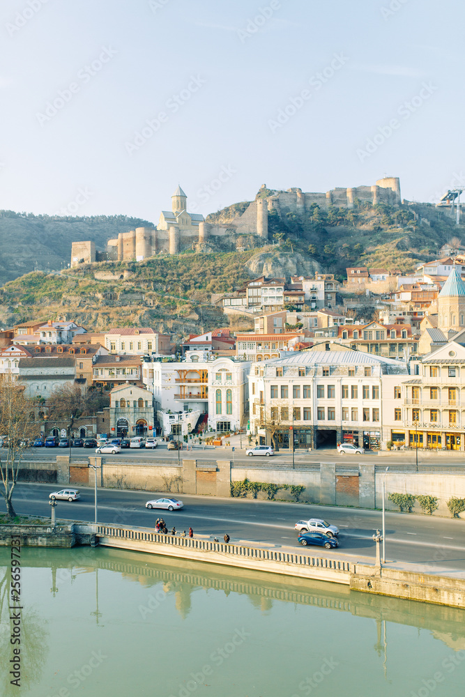 Naklejka premium Dawn in the old city of Tbilisi, Georgia. Panoramas of the ancient city and the fortress.
