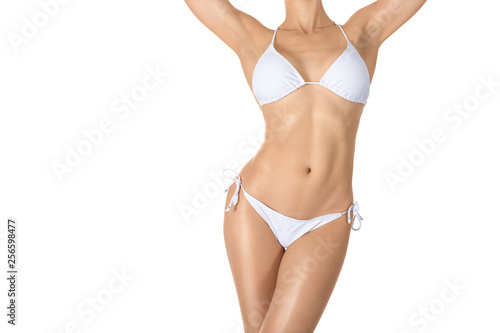Female sexy tanned fit body in white classic bikini, woman raise her arms up, isolated on white