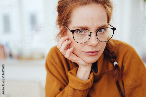 Thoughtful intense young redhead woman