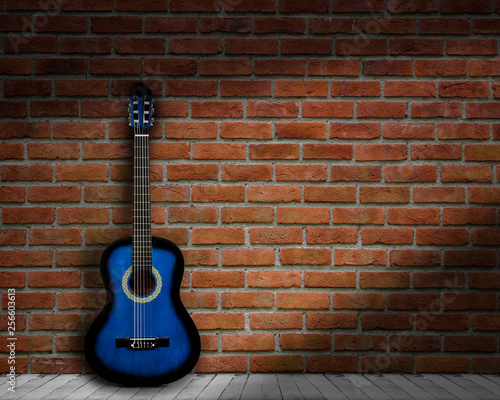 acoustic guitar brick background wall shadow © YB