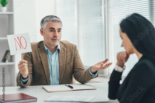 The man and woman are interviewing in the office photo